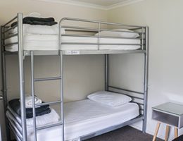white plain bunk bed in dormitory